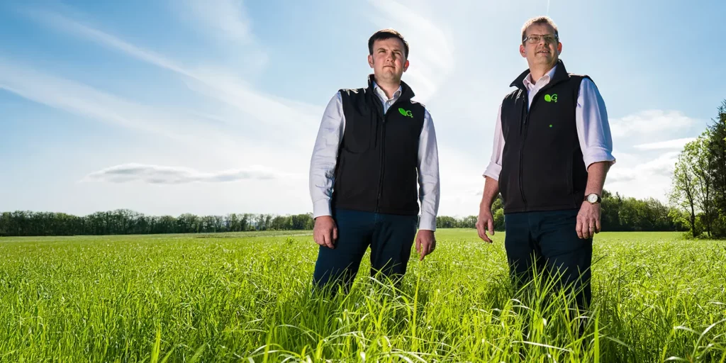 Two Germinal experts standing in a field looking into the distance.